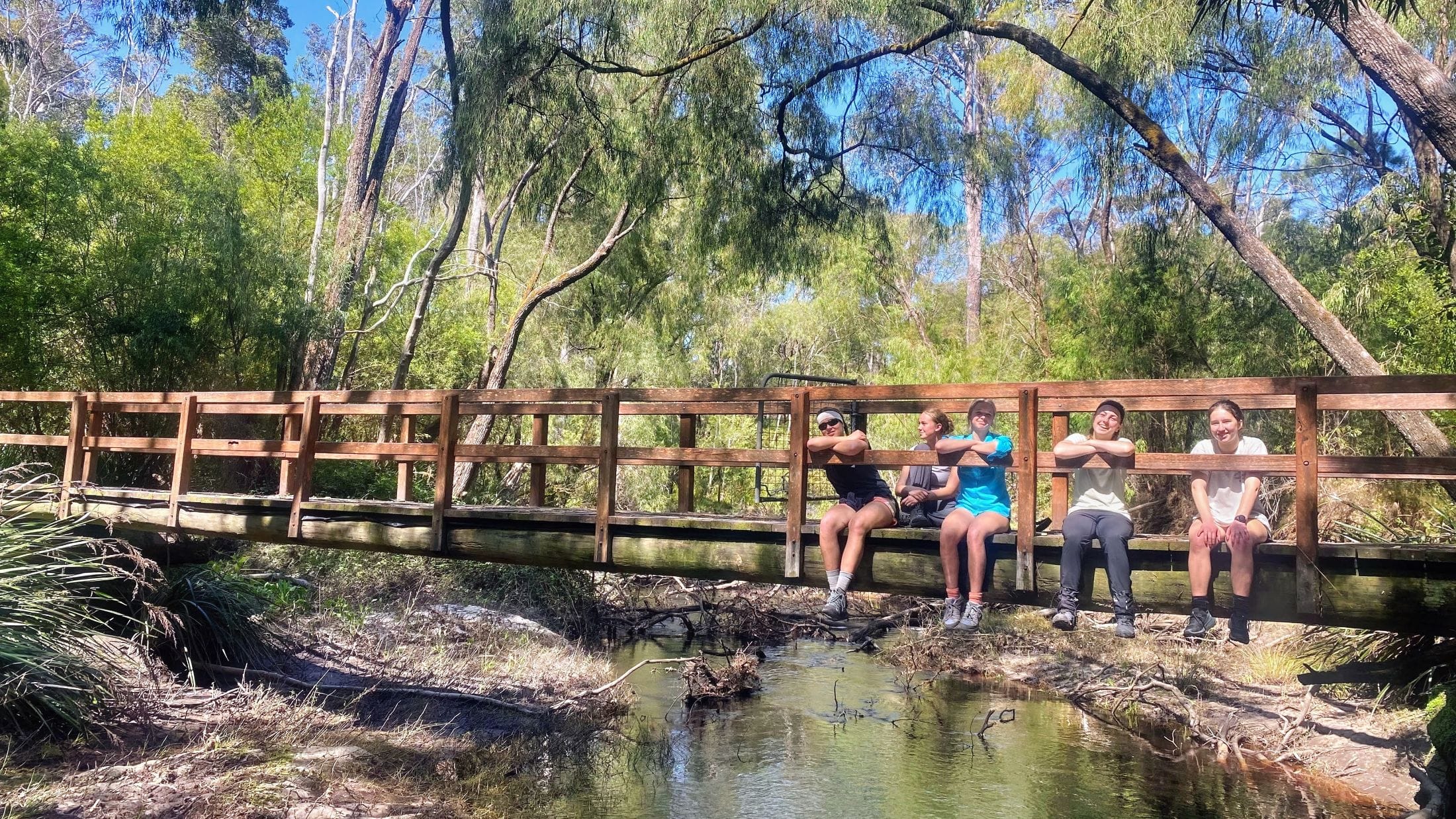 hikers rest on a bridge