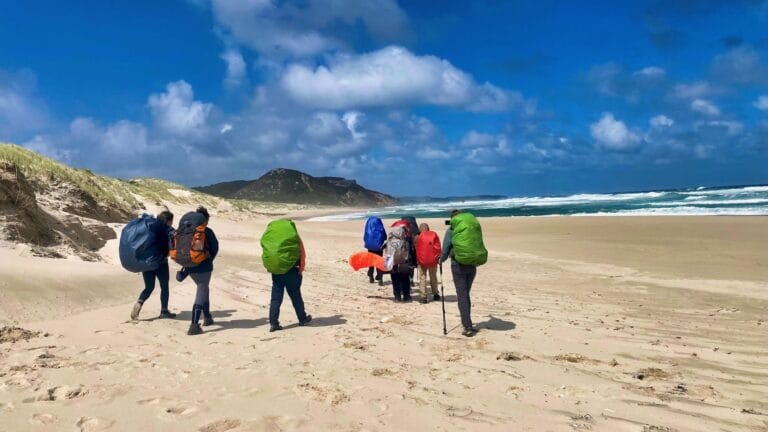 teens hiking on the beach