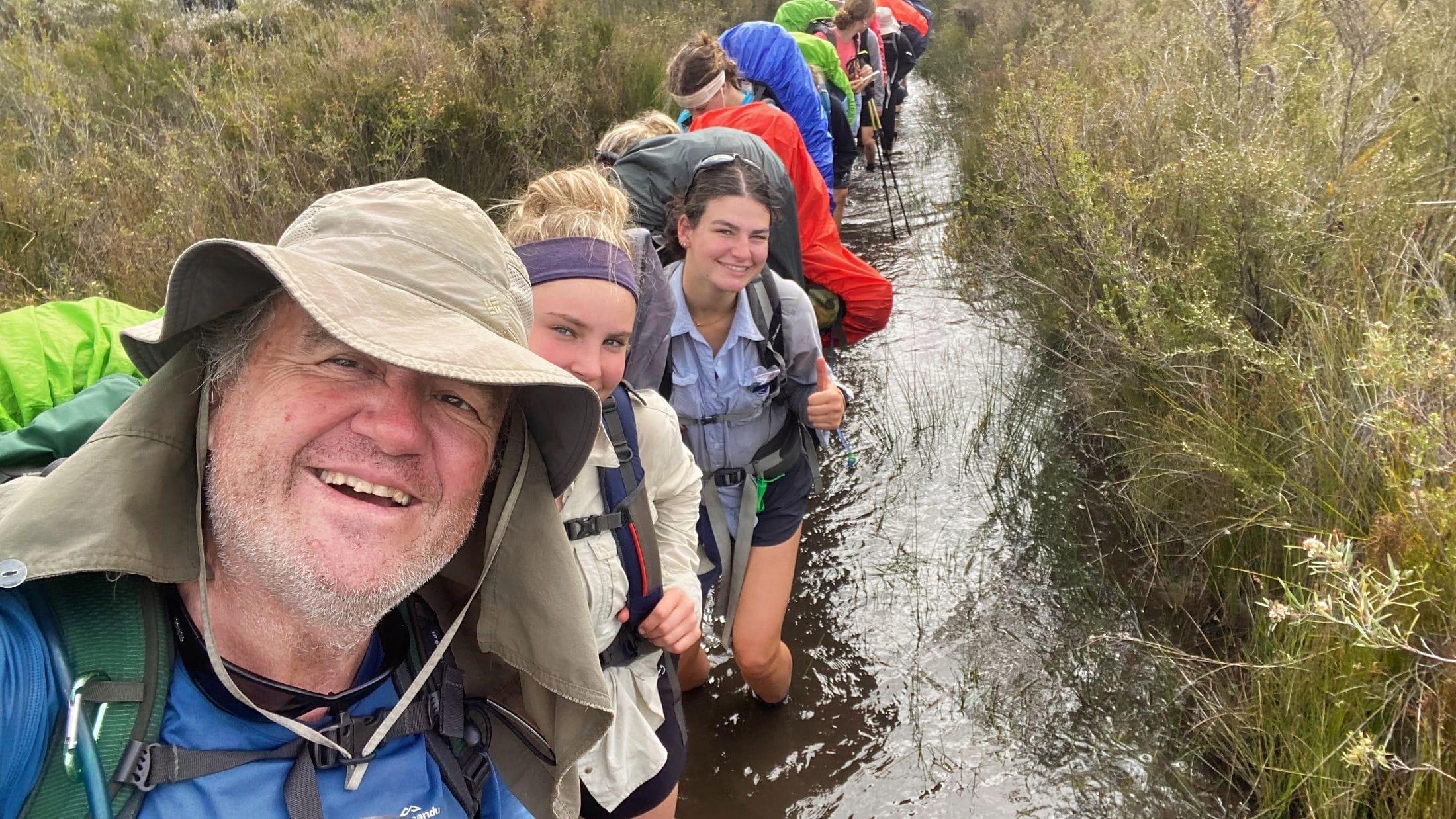 Teen hikers crossing a flooded section of the Bibbulmun Track